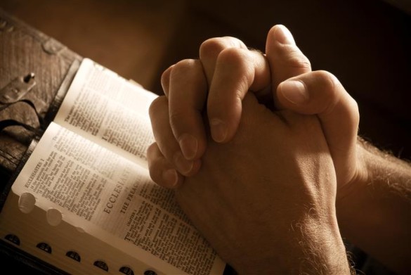bigstock-Praying-Hands-On-An-Open-Bible-3407461-Small